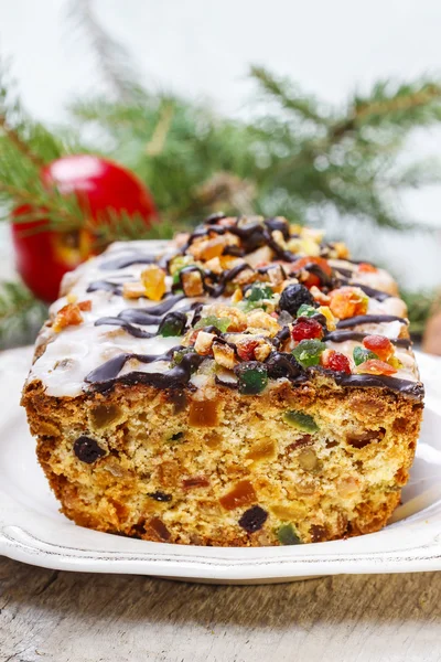 Fruitcake with dried fruits and nuts in christmas setting — Stock Photo, Image