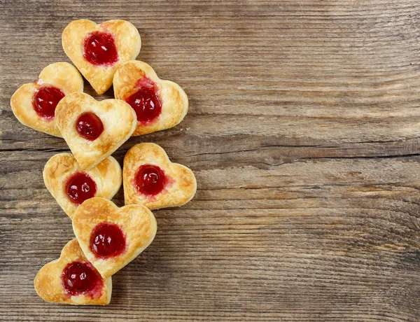 Puff pastry cookies in heart shape filled with cherries — Stock Photo, Image