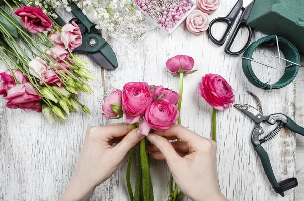 Florist at work. Woman making beautiful bouquet of pink persian Stock Photo