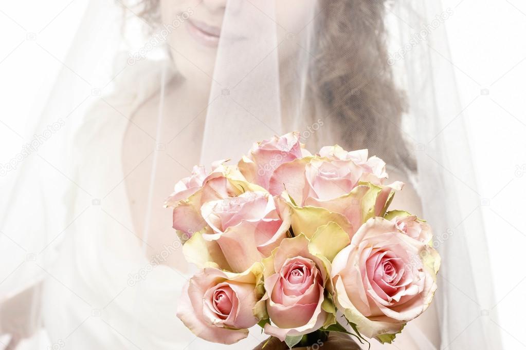 Beautiful young woman holding bouquet of flowers, isolated on wh