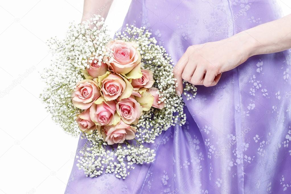 Beautiful young woman holding bouquet of pink roses