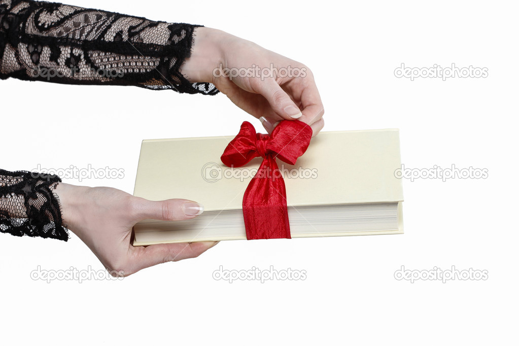 Glamorous woman holding book with big bow