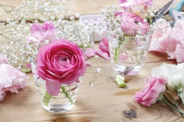Florist workplace: incomplete tiny bouquets in glass vases. Step clipart