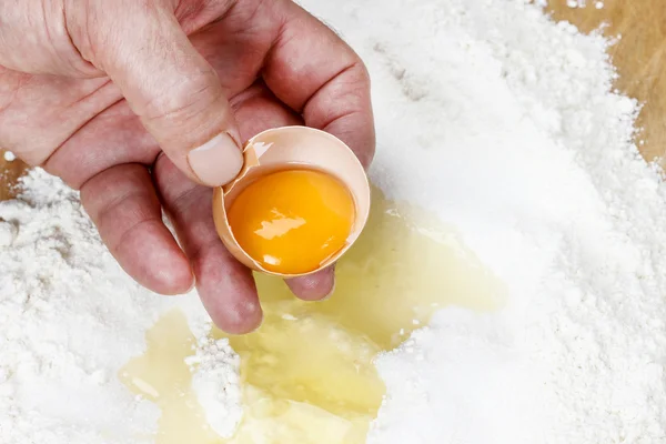 Chef breaking eggs into four to make bread dough — Stock Photo, Image