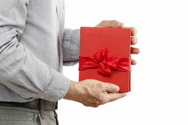 Man gives a book as a present — Stock Photo, Image