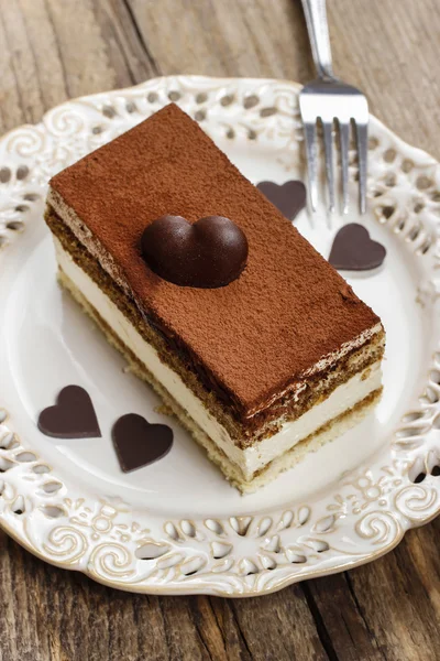 Tiramisu cake and homemade chocolate hearts — Stock Photo, Image