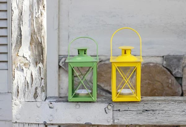 Colorful iron lanterns on rustic wooden porch — Stock Photo, Image