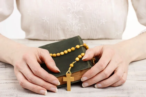 Mulher segurando rosário de madeira e Bíblia Sagrada . — Fotografia de Stock