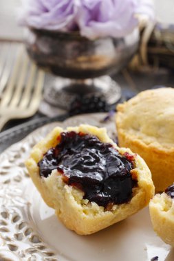 Muffins filled with blueberry and blackberry jam clipart