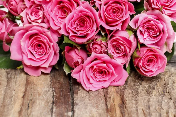 Rosas rosadas sobre fondo de madera —  Fotos de Stock