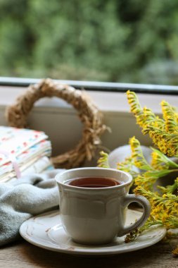 Sonbahar bitkilerinin arasında bir fincan çay. Dinlenme zamanı.