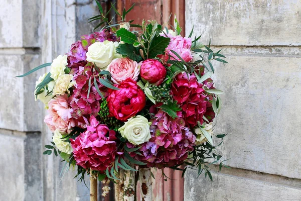 Wedding floral decoration with roses, peonies, hortensias, carnations and other flowers. Party time