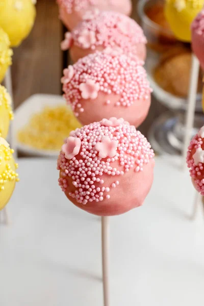 Yellow and pink cake pops. Party dessert