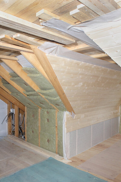 Attic under construction: mounting heat insulation and deal board