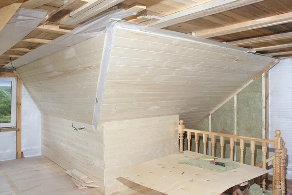 Attic under construction: mounting mineral cotton and deal board — Stock Photo, Image
