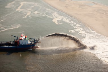 Dredging to create new land clipart