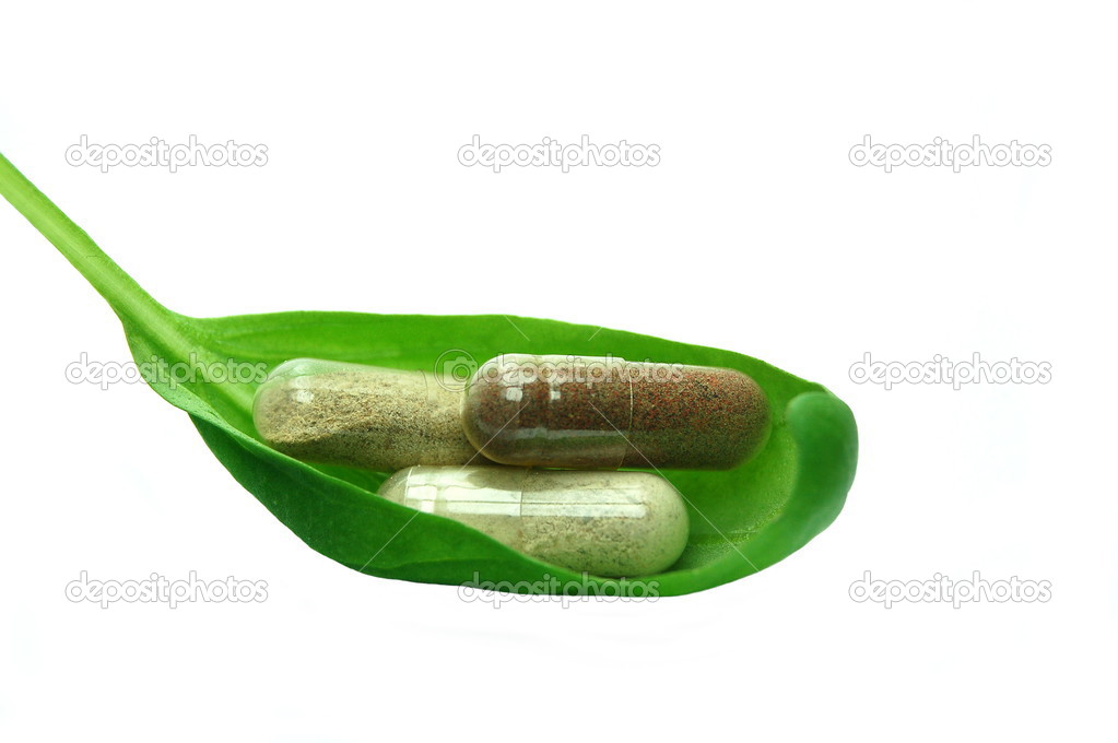 Herbal capsules in basil leaf