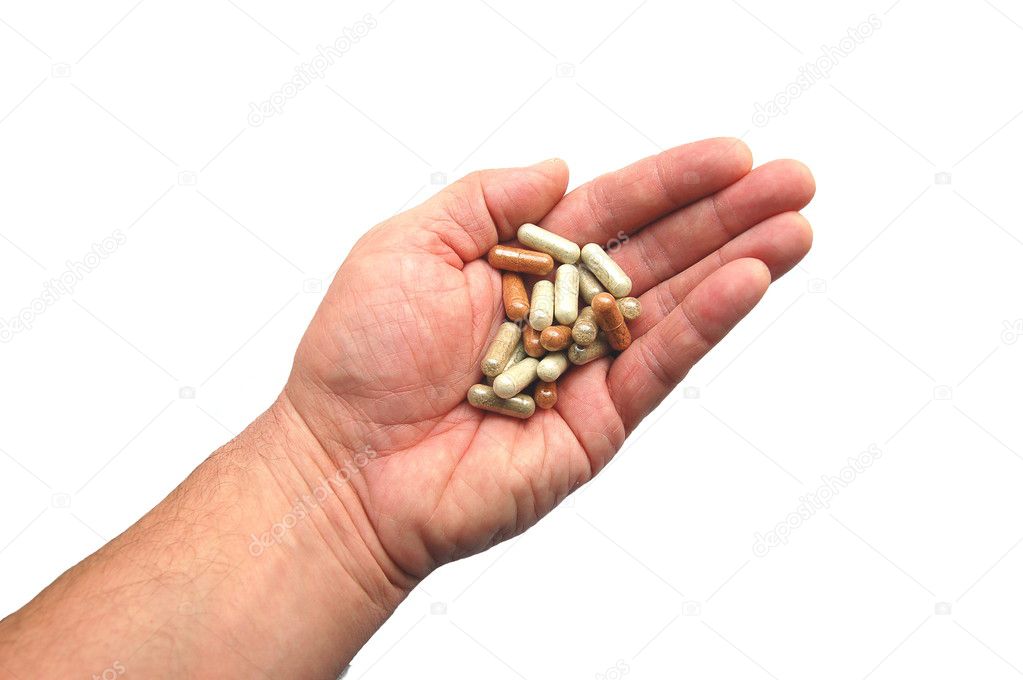 Herbal capsules on a hand