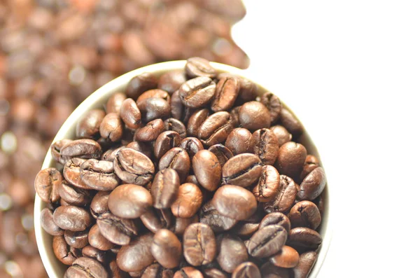 White coffee cup full of coffee beans — Stock Photo, Image