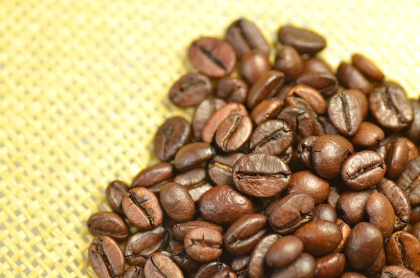 Roasted coffee beans on linen surface — Stock Photo, Image