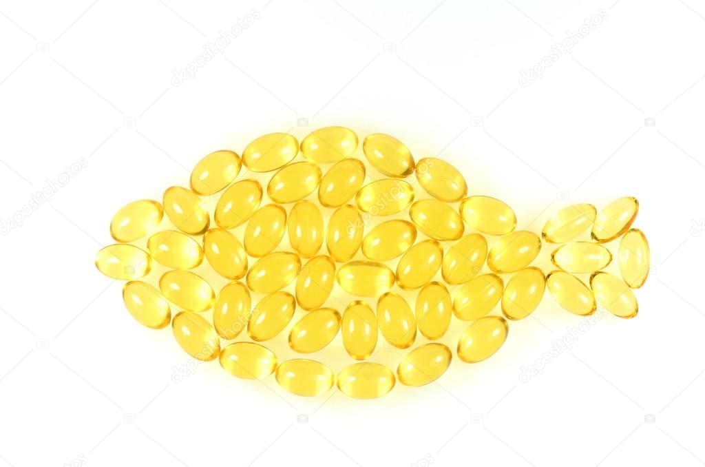 Symbol of fish made of fish oil capsules isolated on white background