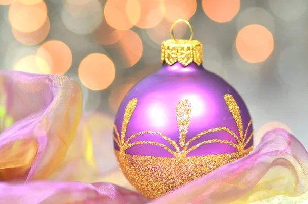 Decoração de Natal, bola de Natal violeta contra fundo bokeh — Fotografia de Stock