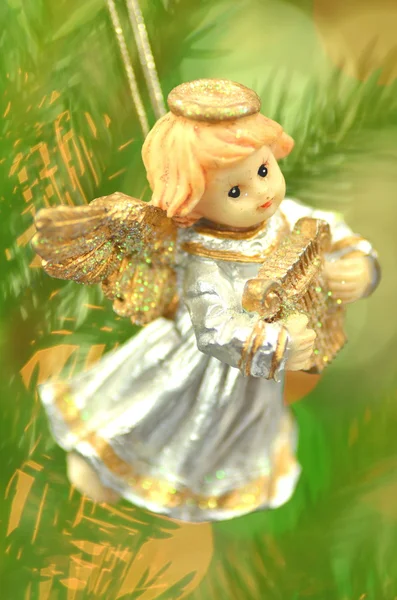 Christmas decoration, figure of little angel playing the harp against bokeh background — Stock Photo, Image