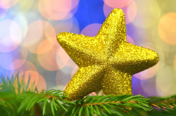 Christmas decoration, golden brocade star against bokeh background — Stock Photo, Image