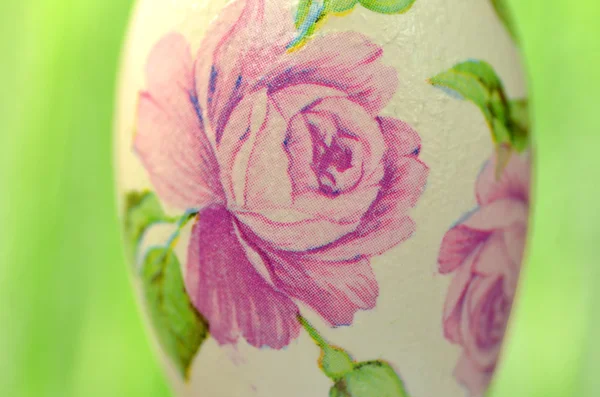 Easter egg decorated with flowers made by decoupage technique on green background — Stock Photo, Image