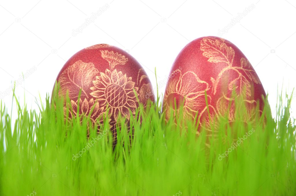 Two traditional scratched handmade Easter eggs in the grass