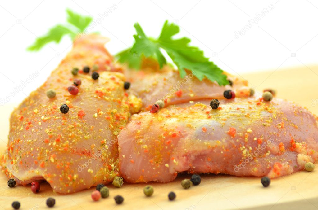 Raw chicken meat on cutting board isolated on white