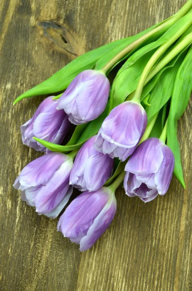Bukiet piękne fioletowe tulipany na prosty drewniany stół — Zdjęcie stockowe