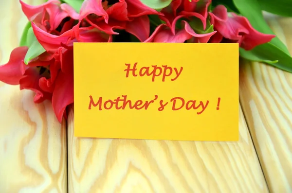 Happy mothers day and bouquet of gorgeous red tulips — Stock Photo, Image