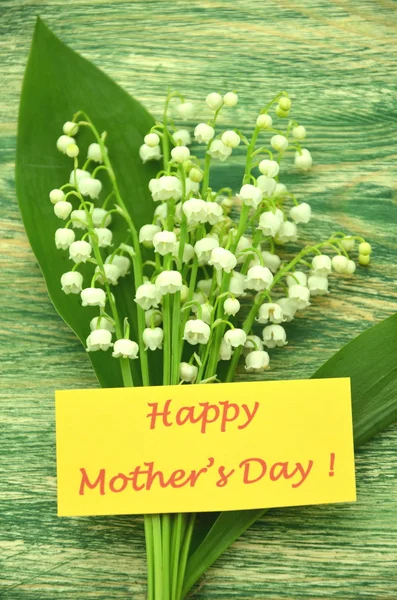 Happy mothers day and bouquet of delicate fresh lilies of the valley — Stock Photo, Image