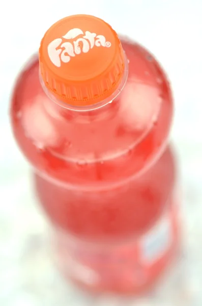 Bottle of Fanta drink on ice cubes — Stock Photo, Image