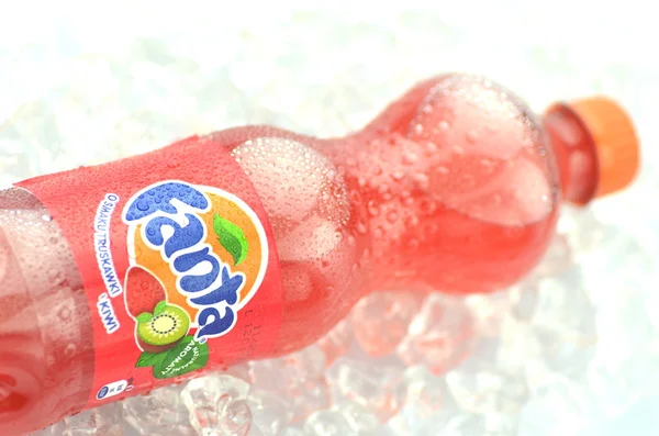 Bottle of Fanta drink on ice cubes — Stock Photo, Image