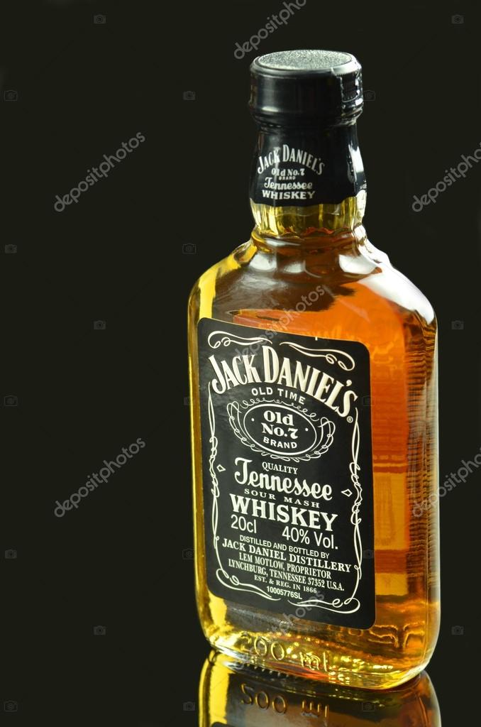 Small bottle of Jack Daniels whiskey isolated on dark background