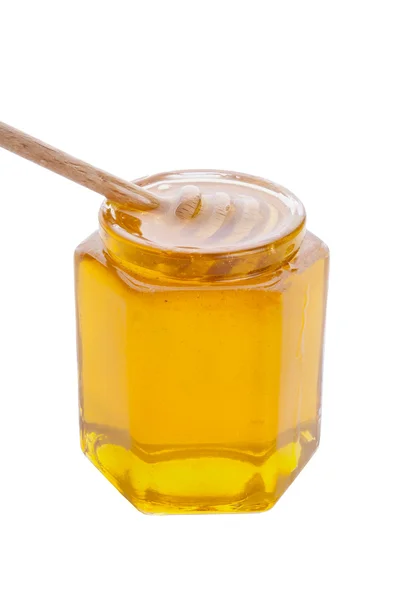 Tarro de vidrio de miel con rociador de madera —  Fotos de Stock