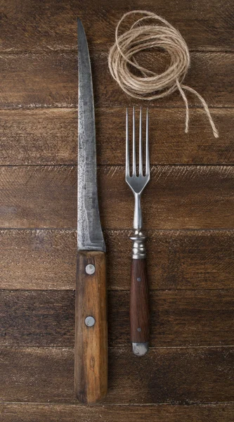 Vintage knife and fork on wooden background — Stock Photo, Image