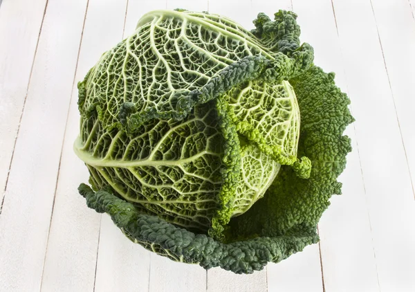 Fresh Savoy Cabbage on wooden background — Stock Photo, Image