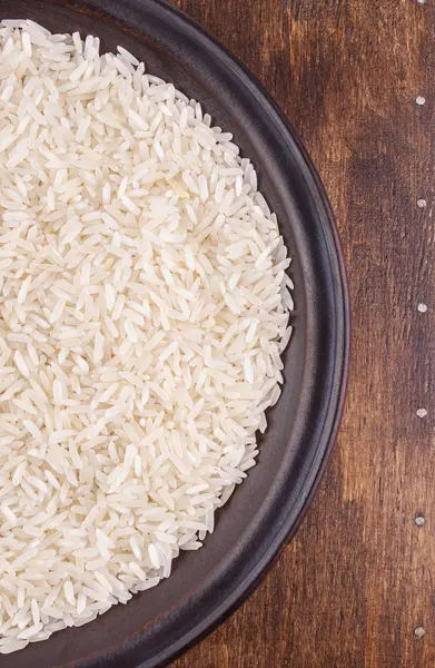 Plate of Rice on Dark Wood Background — Stock Photo, Image