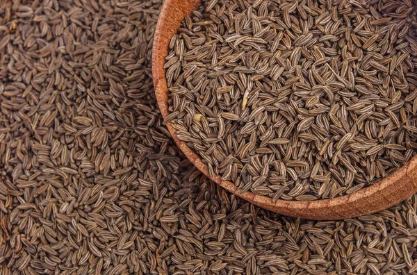 Cumin seeds in a wooden plate — Stock Photo, Image