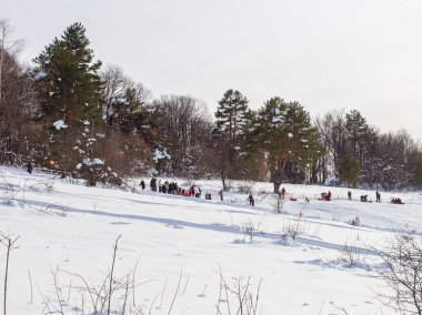 Maykop, Adygea Cumhuriyeti, Rusya Federasyonu, 01. - 24. 2021: Dağlarda aile tatili, dondurucu kış sabahı, kar motosikleti ve şişme kızak, yeni yıl tatili.