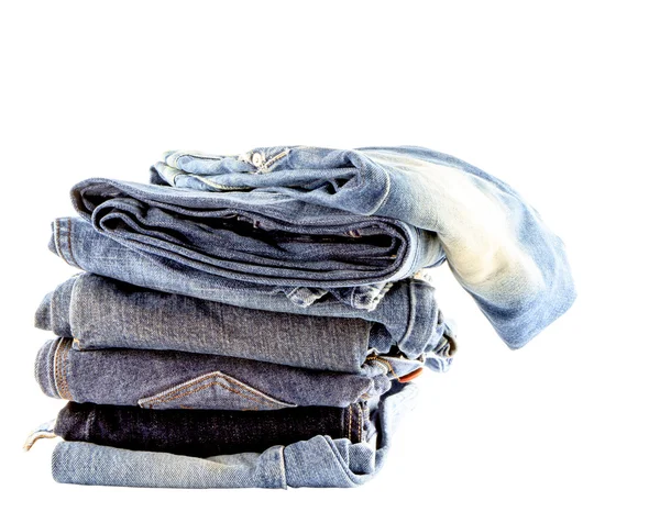 Pila de jeans aislados sobre fondo blanco — Foto de Stock