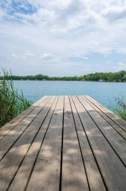 Wooden footbridge with views of Banyoles lake