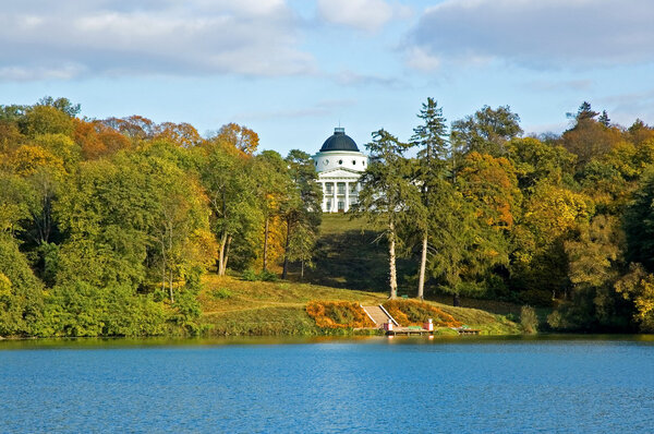 Autumn park with a lake and the palace