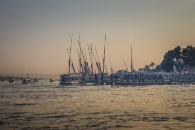 Luxor, Mısır - 10 Ekim 2021: Eski Luxor 'un batı ve doğu kesimleri arasında Nil Nehri. Luxor 'daki Nil' de tekne ve yatlar