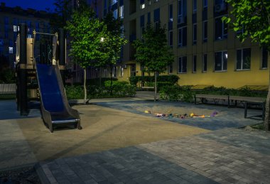 Night park paths and colored houses at summer night. Night paths, benches and lanterns in a beautiful residential complex. Night summer park with lanterns and benches. Kyiv. Ukraine