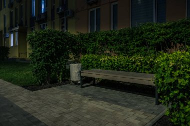 Night park paths and colored houses at summer night. Night paths, benches and lanterns in a beautiful residential complex. Night summer park with lanterns and benches. Kyiv. Ukraine