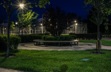 Night park paths and colored houses at summer night. Night paths, benches and lanterns in a beautiful residential complex. Night summer park with lanterns and benches. Kyiv. Ukraine